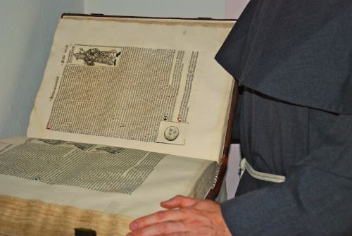man holding old book